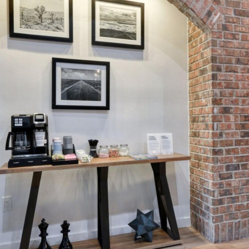 Everything within reach a common room coffee station with exposed brick walls