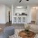a living room with a table and chairs and couch and kitchen bar