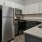 a kitchen with white cabinets and granite countertops