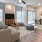 a living room with a wood floor a couch and a dining table